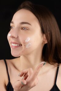  A teenage girl applying face cream