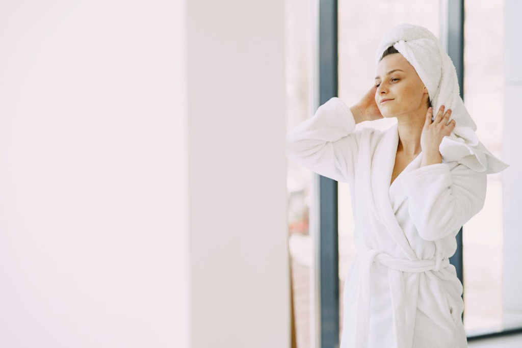 A Woman in a Robe and Towel Turban Admires the Makeup Removing Prowess of the Papaya Cleanser