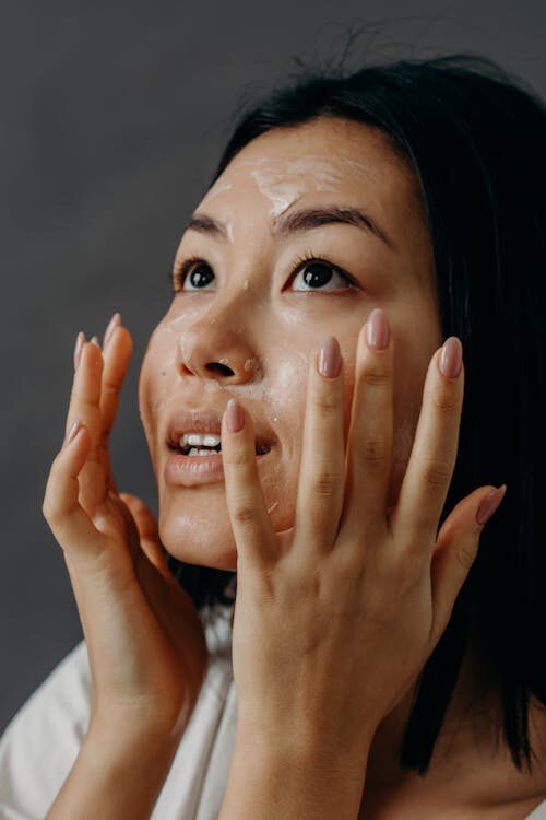 A Woman Applies Cleanser for Removing Makeup Residue