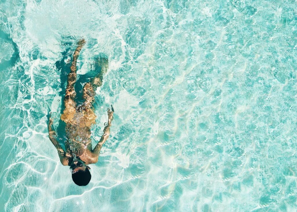 A swimmer in a pool with SPF on