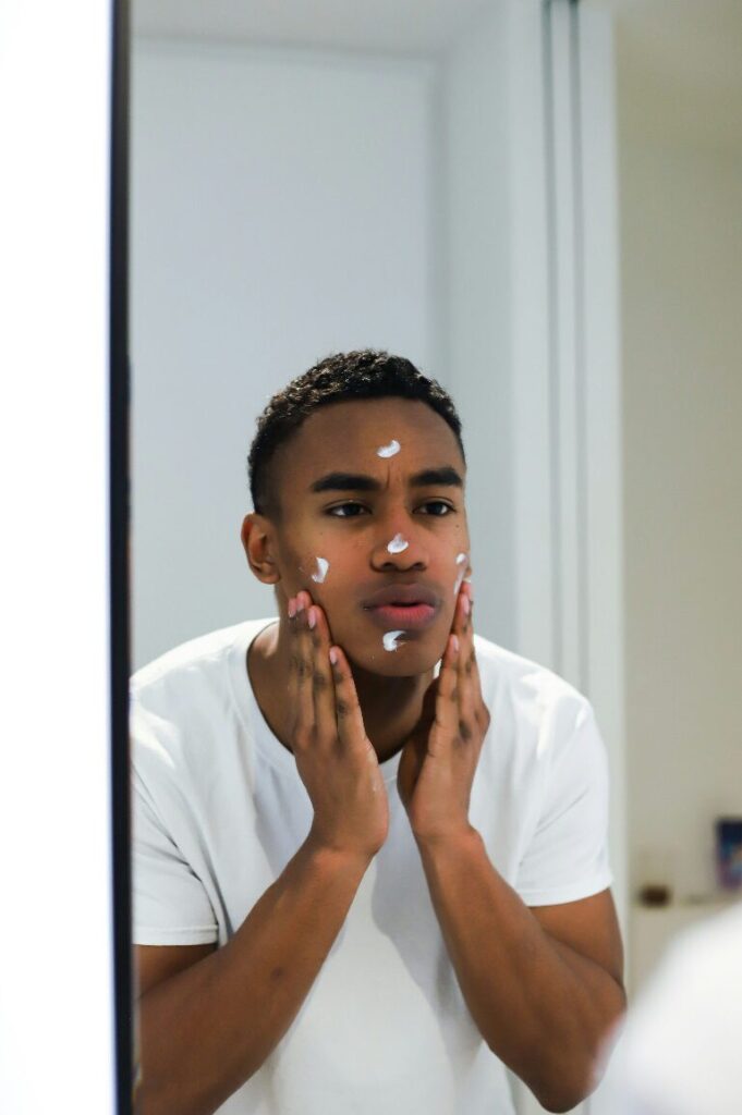 a man standing in front of a mirror