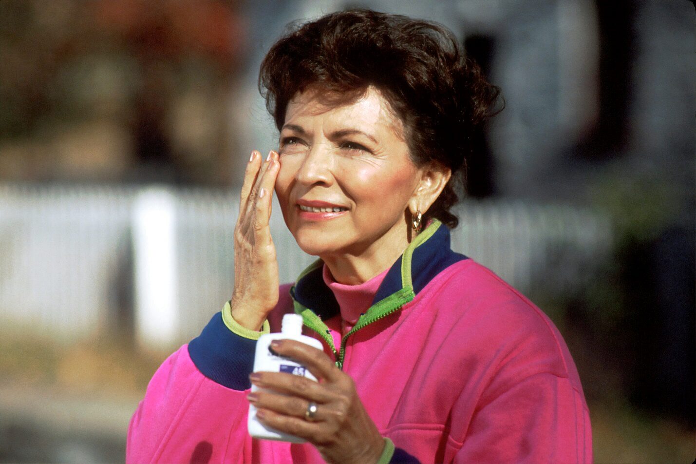 A woman applying sunscreen