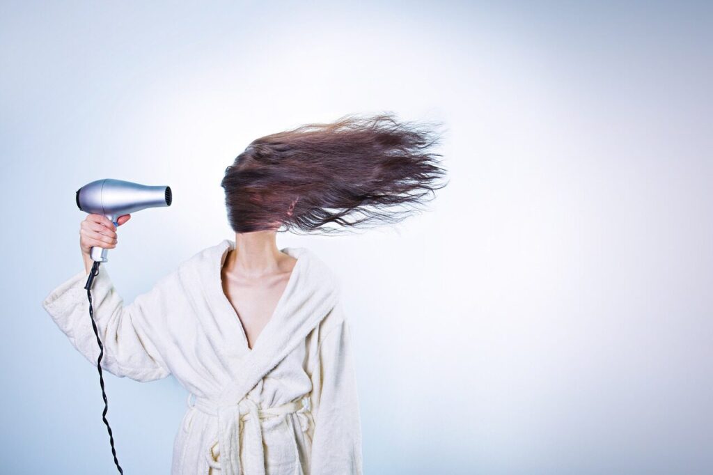 A woman using a hairdryer