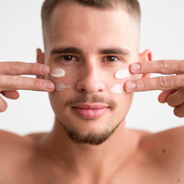 a man applying moisturizer to his face